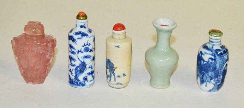 Five Asian Table Articles: A group of asian table articles including three blue and white snuff bottles with lids; a celedon vase and a rose colored hard stone snuff bottle. Largest 3.5"