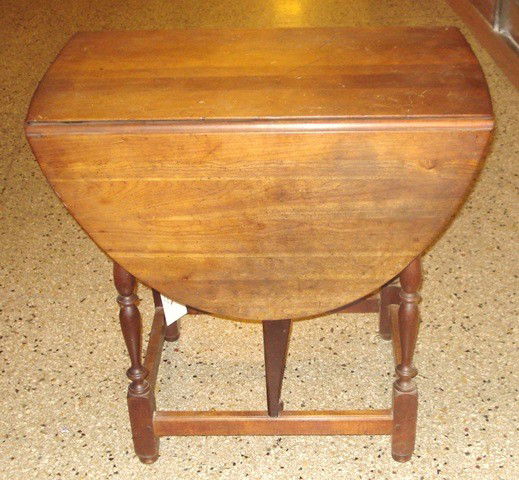 Drop-Leaf Table: Mahogany table having turned columns and one drawer. Good condition, some wear. 29.75" H x 15" W (closed), 44" W (open) x 29.75" D