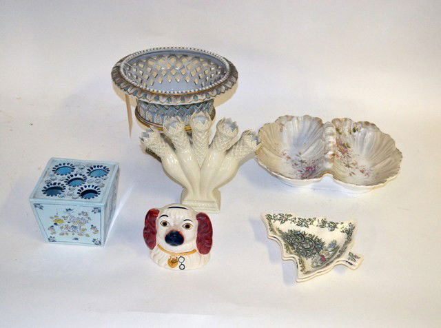 7 Assorted Porcelain Items: A large group of assorted porcelain table articles including a KPM handled serving dish; Delft flower box; two Christmas form Johnson Bros plates, a lattice footed center bowl and a Staffordshire dog