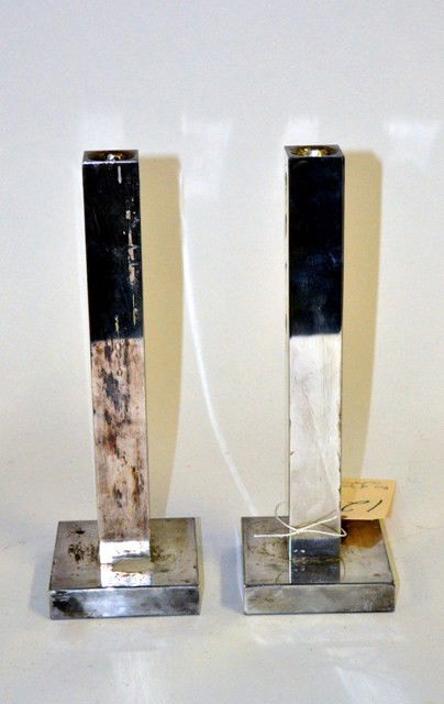 Pair of Swid Powell Candlesticks: Pair of chrome candlesticks by Swid Powell, for Calvin Klein. Worn condition. 10" x 3.5" x 3.5"