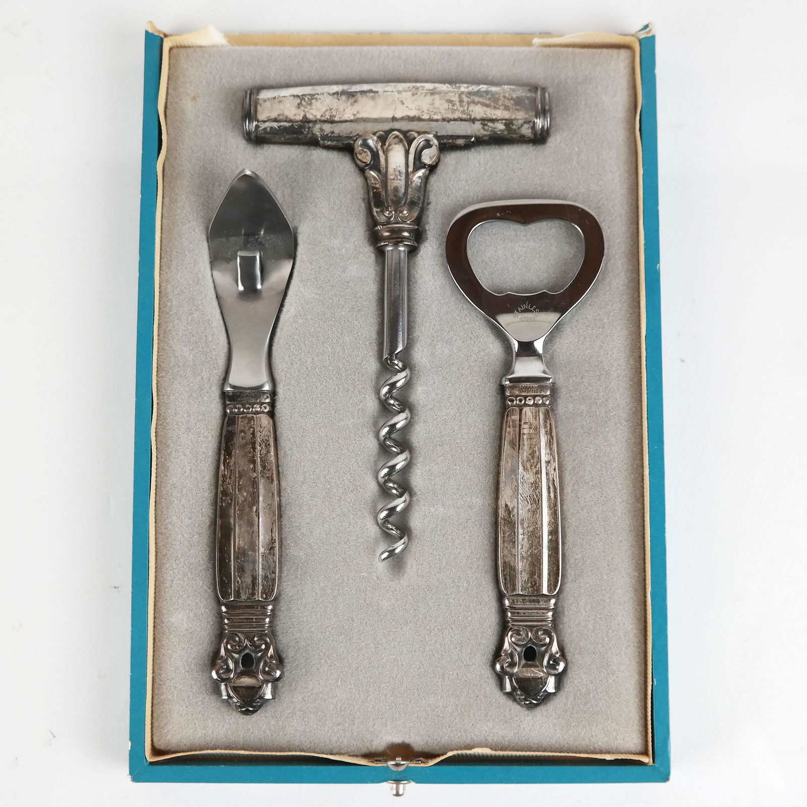 Georg Jensen Sterling Silver Bar Set: Georg Jensen sterling silver bar set in the acorn pattern, with steel ends (not weighable), includes a wine opener, a bottle opener, and a can opener in a partial fitted case. [4 3/4" Long]. Case miss