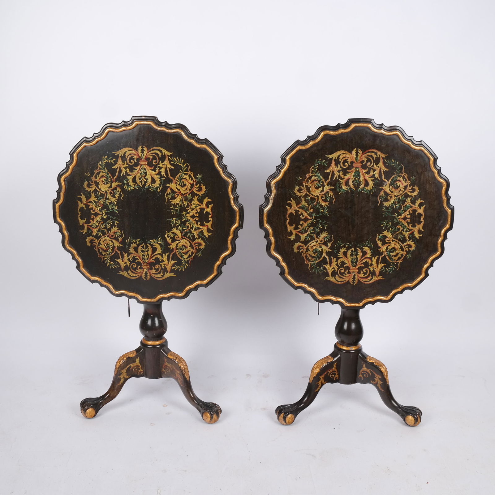Pair of Antique Decorated Tilt Top Tables: Pair of 19th century scalloped and decorated tilt top tables on ball and claw feet. [Tilted: 39 1/2" H x 24" Diam.; Top down: 26 1/2" H x 24" Diam.].