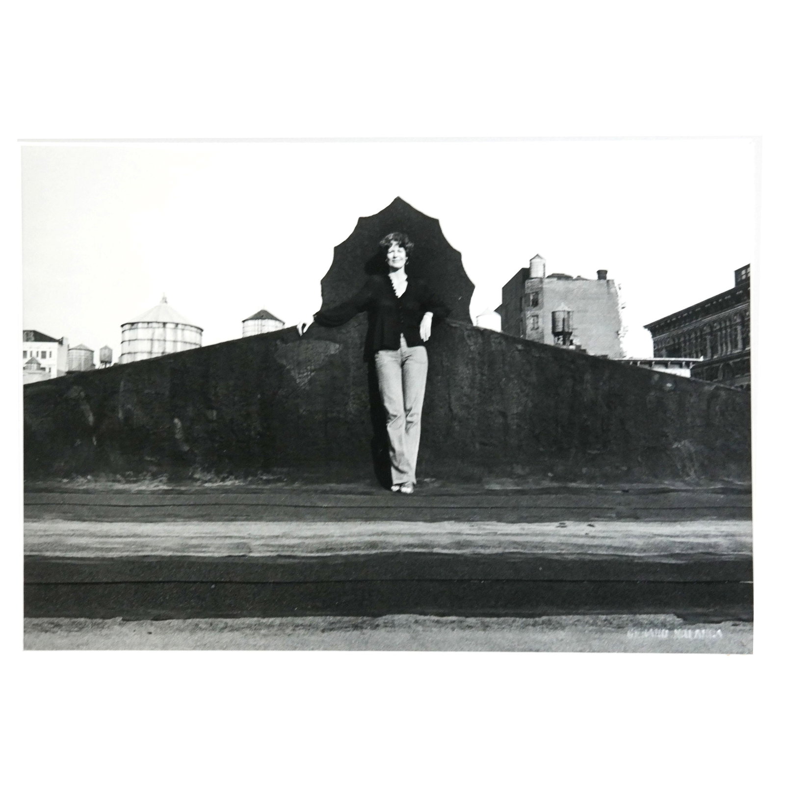 Gerard MALANGA: Photograph of Women on a Rooftop: Gerard Malanga (American, b. 1943) photograph of woman on a rooftop. Embossed signature lower left. [Photo: 6 1/2" H x 9 1/2" W; Frame: 12 1/4" H x 16 1/2" W]. In overall good condition.