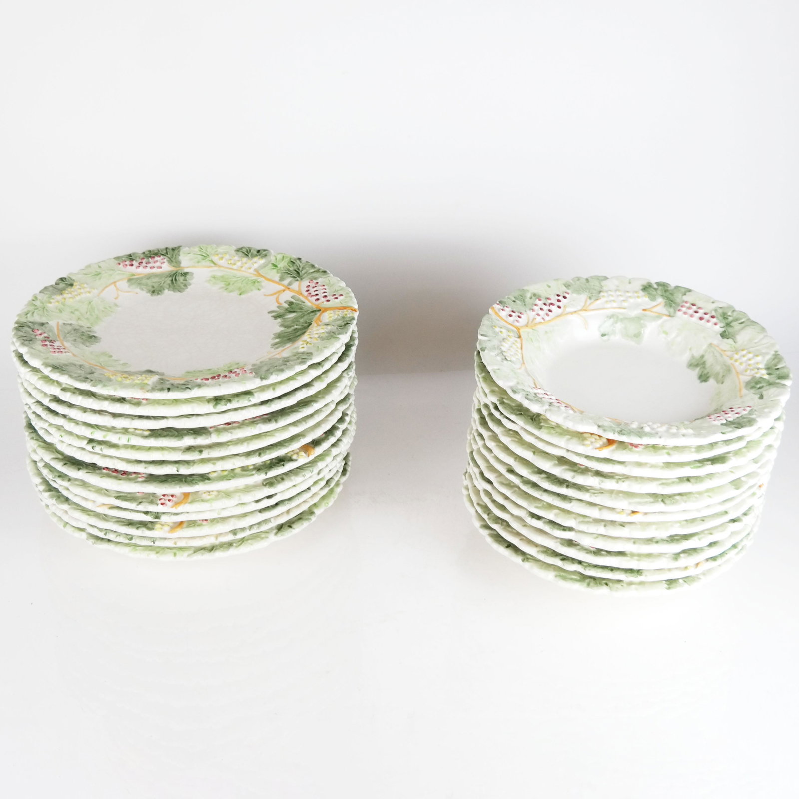 23 Monte Follonico Italian Maiolica Bowls & Plates: Monte Follonico Italian Maiolica bowls and plates with grape vine and leaf decoration, marked to base. 23 pieces total. [10 1/4" Diam.]. Some marks and wear.