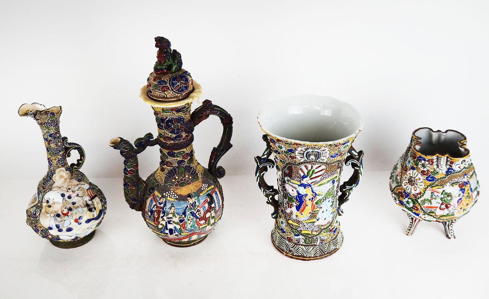 Four Japanese Porcelain Colorful Vessels: Four Japanese porcelain colorful vessels with raised designs, comprising two vases and two pitchers. [Tallest: 14" H (with lid)]. As is.