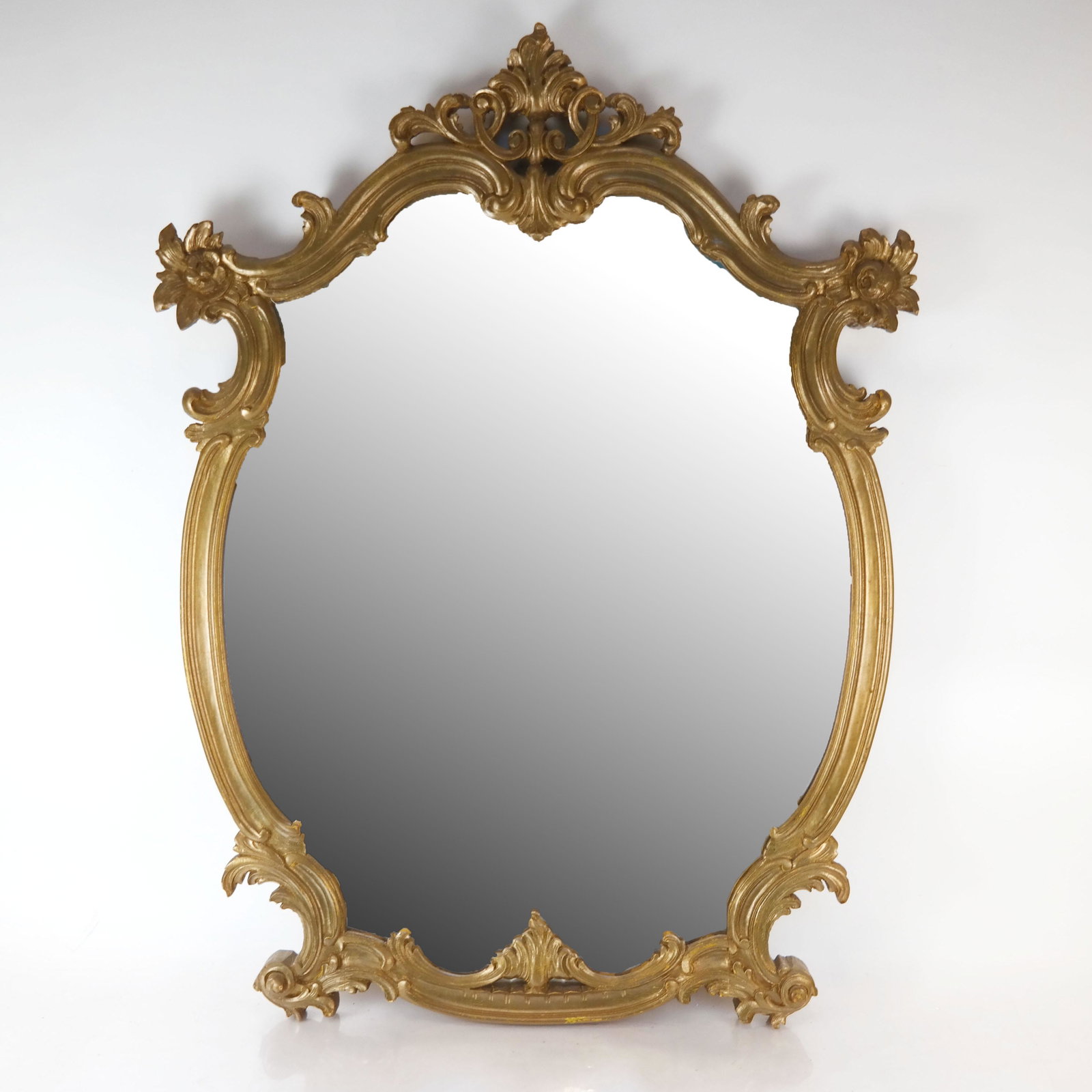Rococo-Style Giltwood Mirror: Rococo-style giltwood mirror. [39" H x 29" W x 2 1/2" D]. Wear and losses to decoration.