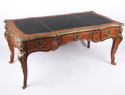 Louis XV-Style Gilt Bronze Mounted Bureau Plat: Louis XV-style gilt bronze mounted bureau plat, after a model by Charles Cressent (French, 1685-1768), the desk with inset tooled leather writing pad above the four legs with figural espagnolettes and