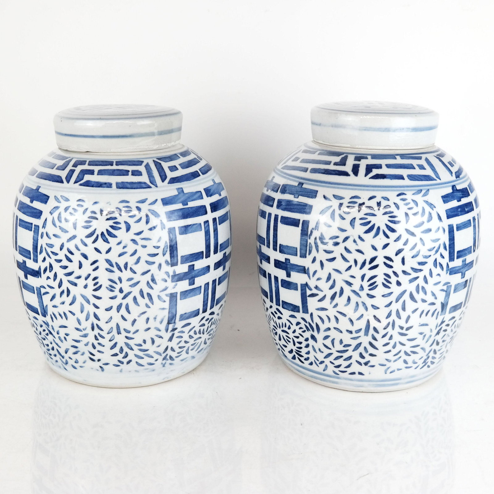 Pair of Chinese Blue & White Ginger Jars: Pair of Chinese blue and white ginger jars with leaf and character marks, marked to bases. [10" H x 8" Diam.]. In good condition, minor wear.