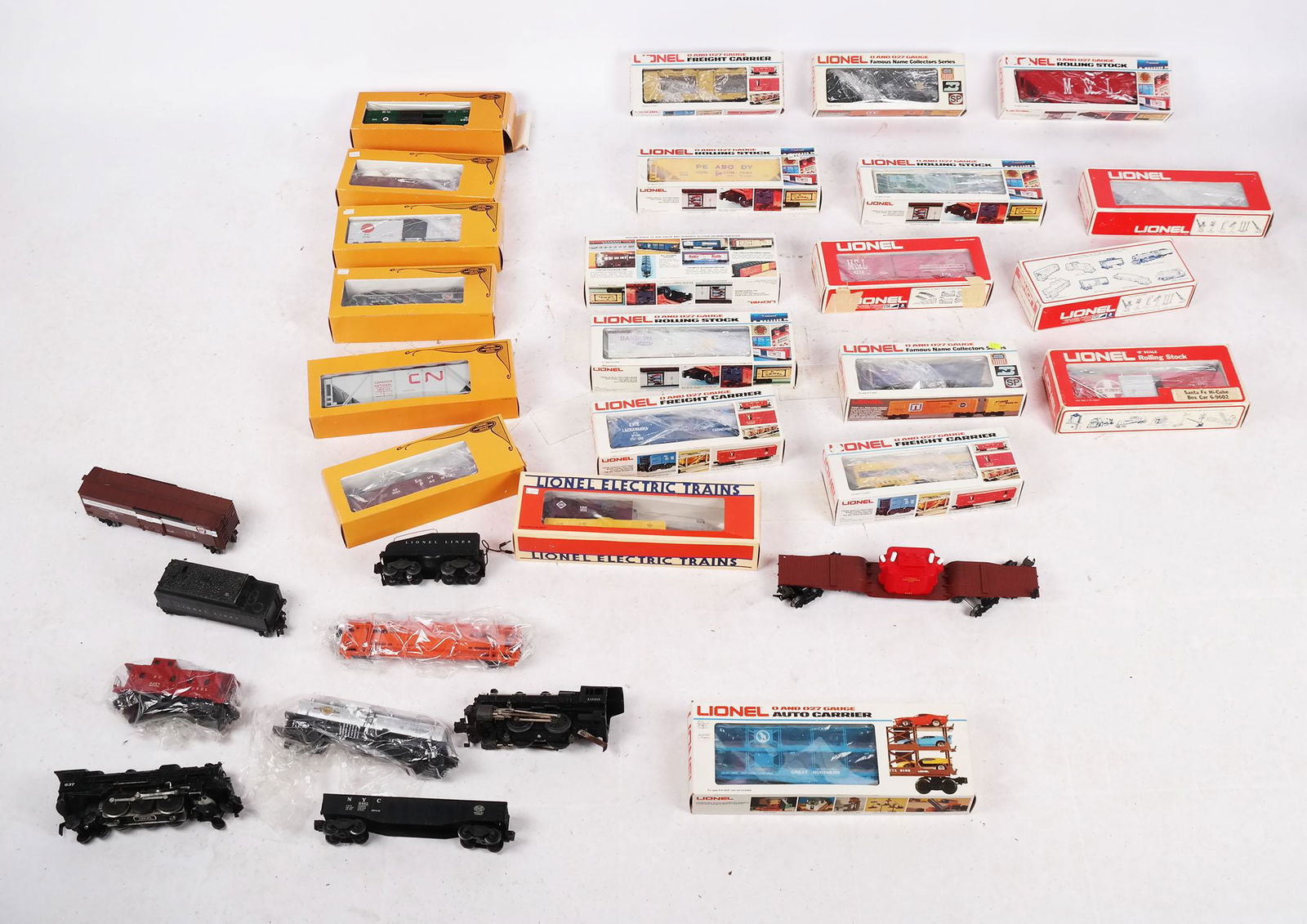 Assembled Group of 31 Lionel Train Car Sections: Assembled group of 31 Lionel Train car sections, including box cars, reefers, hopper, gondola, cattle car, and others, some Limi, many with original boxes, some without. [Largest box: 5" H x 18 3/4" W