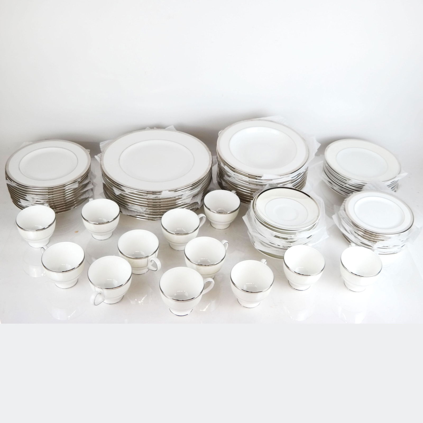 83 Pc. Lenox & Wedgwood Bone China Partial Service: 83 piece Lenox and Wedgwood bone china partial service, in the Lenox "Murray Hill" and Wedgwood lusterware "Oyster" patterns, comprising 12 dinner plates, 24 salad plates, 13 soup bowls, 11 bread plat