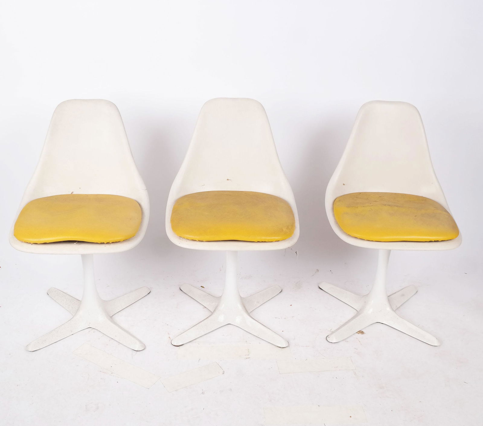 Three Maurice Burke Fiberglass Tulip Chairs: Three Maurice Burke mid-century fiberglass "tulip" chairs, marked to bases. [32" H x 19" W x 20" D]. Frames with cracks, stains and wear. Stains and wear to fabric.