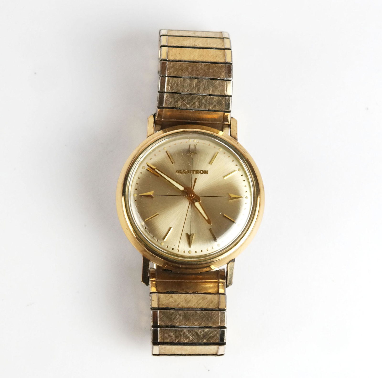 20th Century Accutron (Bulova) Wrist Watch: 20th century Accutron (Bulova) wrist watch having a 10K yellow gold filled bezel, quartz movement, and yellow gold-plated flex band. Serial #A12341. [Bezel: 1-3/8” Diam.]. In fair condition.