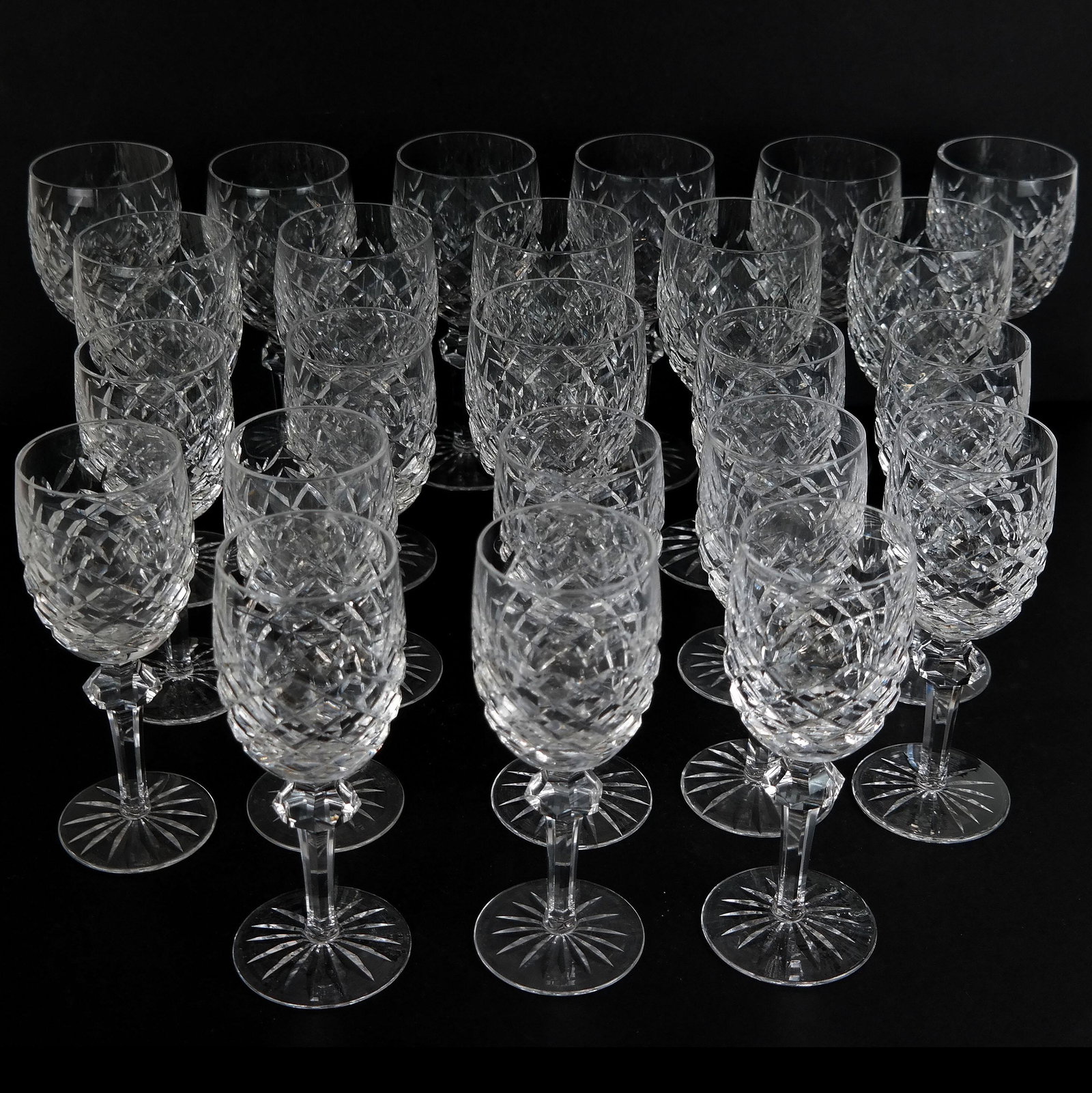 Waterford Cut Crystal Stemware (24): Lot of 24 Waterford cut crystal stemware in the "Powerscourt" pattern, comprising 12 water goblets and 12 claret wine glasses, marked to bases. [7 5/8" H and 7 1/8" H]. A couple with tiny "flea bite" 
