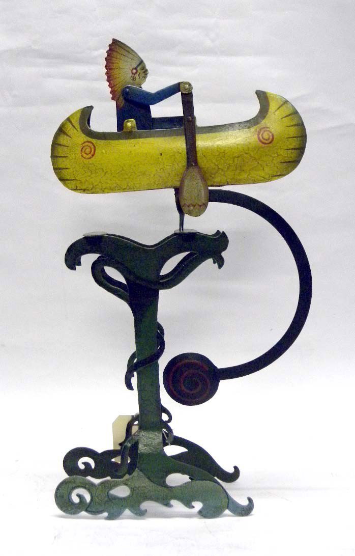 Metal Native American Indian Balance Toy: A hand-painted metal Native American Indian balance toy with an Indian in a canoe. 23" H.