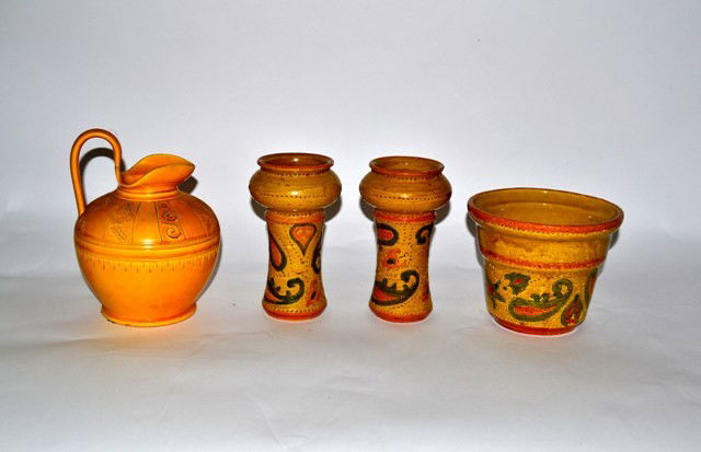 Three Pieces, Raymor Bitossi: Jardenier and two candlesticks with glazed motifs together with yellow pottery pitcher with yellow pottery pitcher, by Raymond Bitossi. Tallest 7".