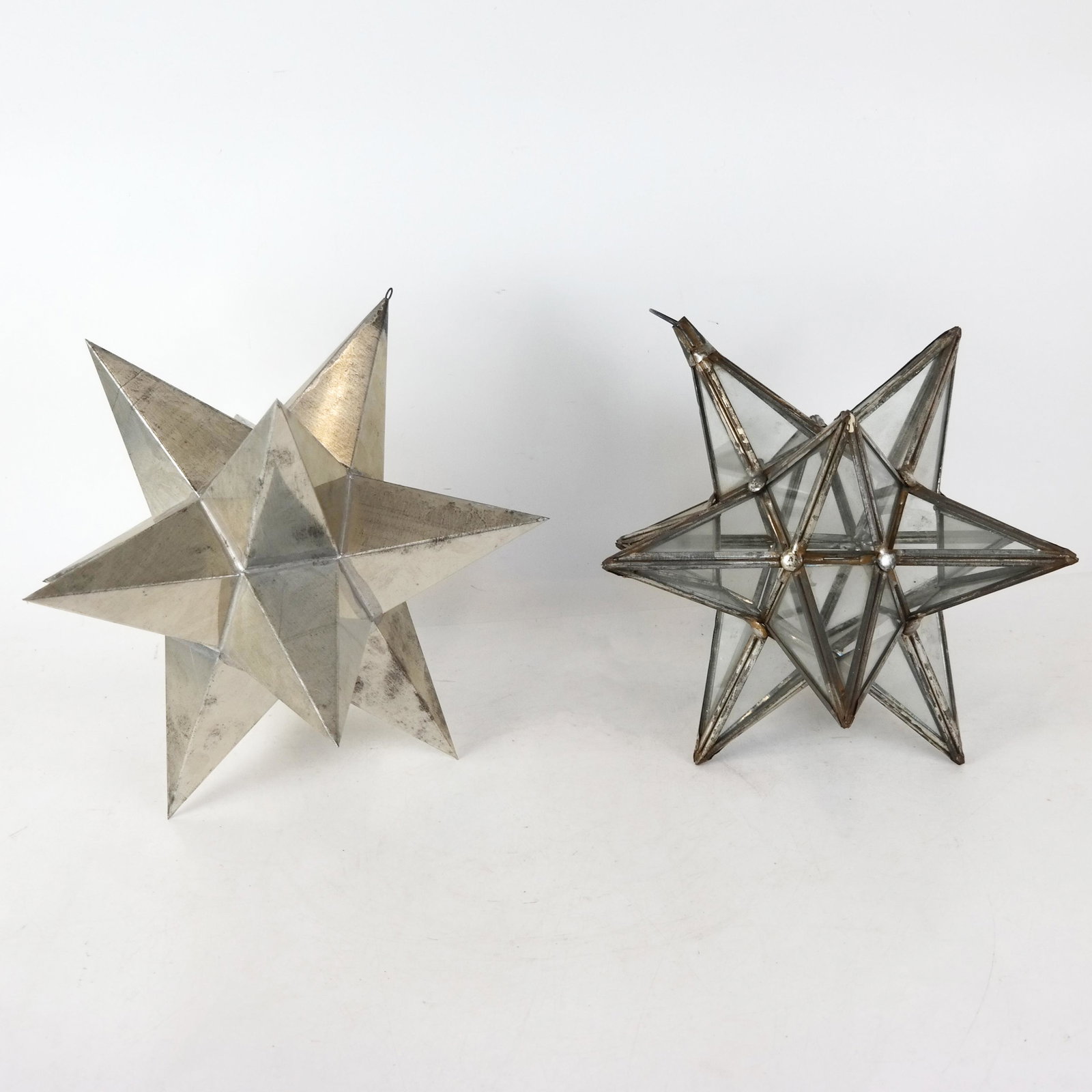 Two Holiday Pendant Stars: Two holiday pendant stars. [Larger: 13 1/2" H x 13" Diam.]. Some oxidation and bending to metal.