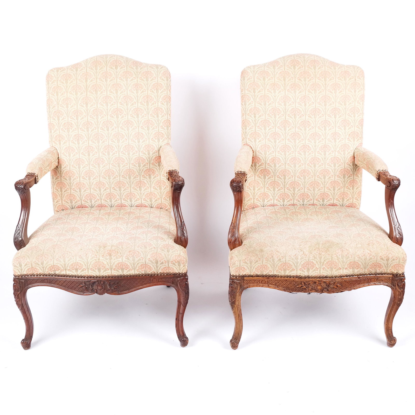 Pair of Louis XV-Style Armchairs: Pair of Louis XV-style armchairs, the carved frames with hatch and foliate details with floral upholstery. [41 1/2" H x 26 1/2" W x 26" D]. Some marks and wear to frames, marks to upholstery.