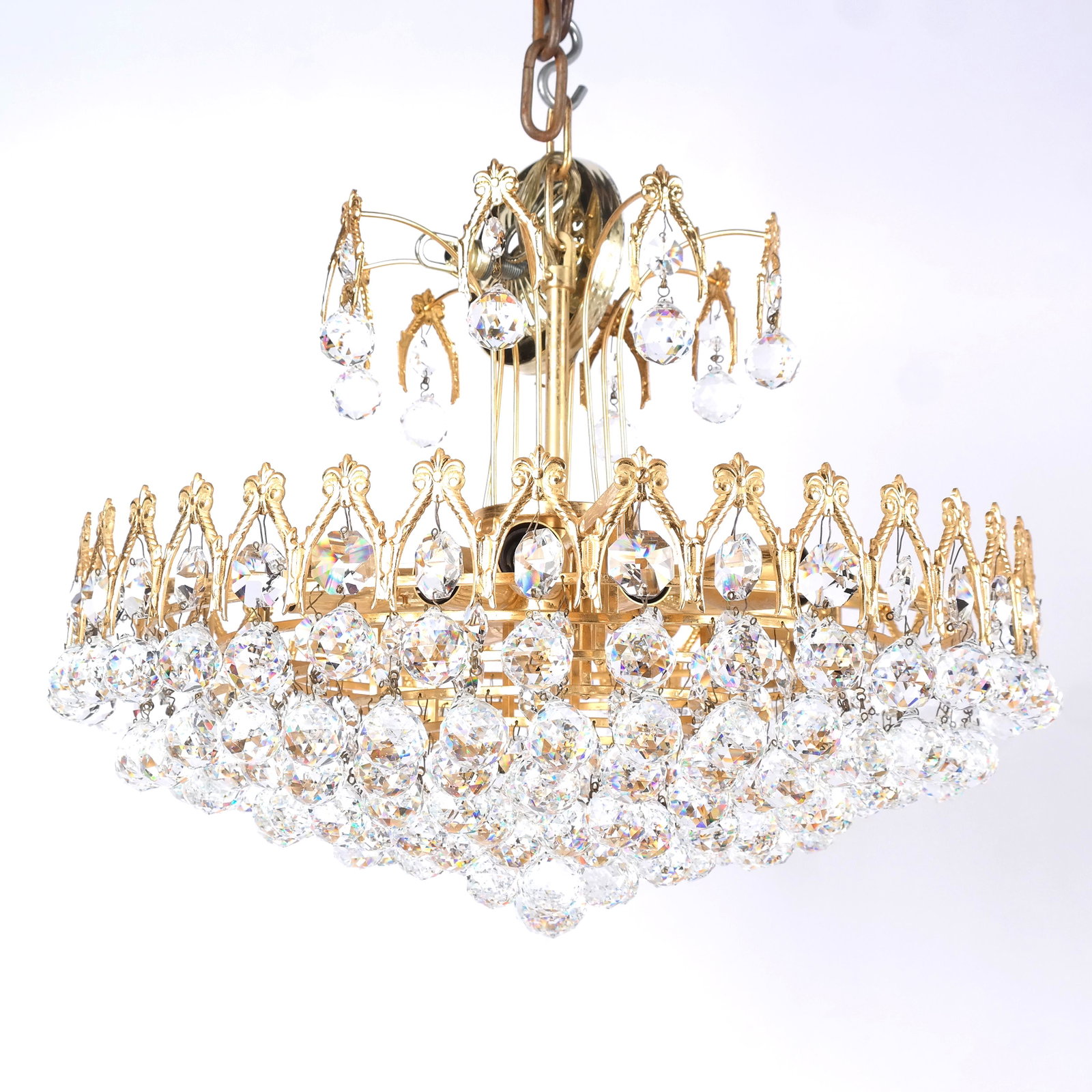Modern Gilt Metal & Crystal Chandelier: Modern gilt metal and crystal chandelier with gothic-style lancet arches above tiers of faceted round prisms. En suite with following lot. [16" H x 20" Diam.]. In overall good condition.
