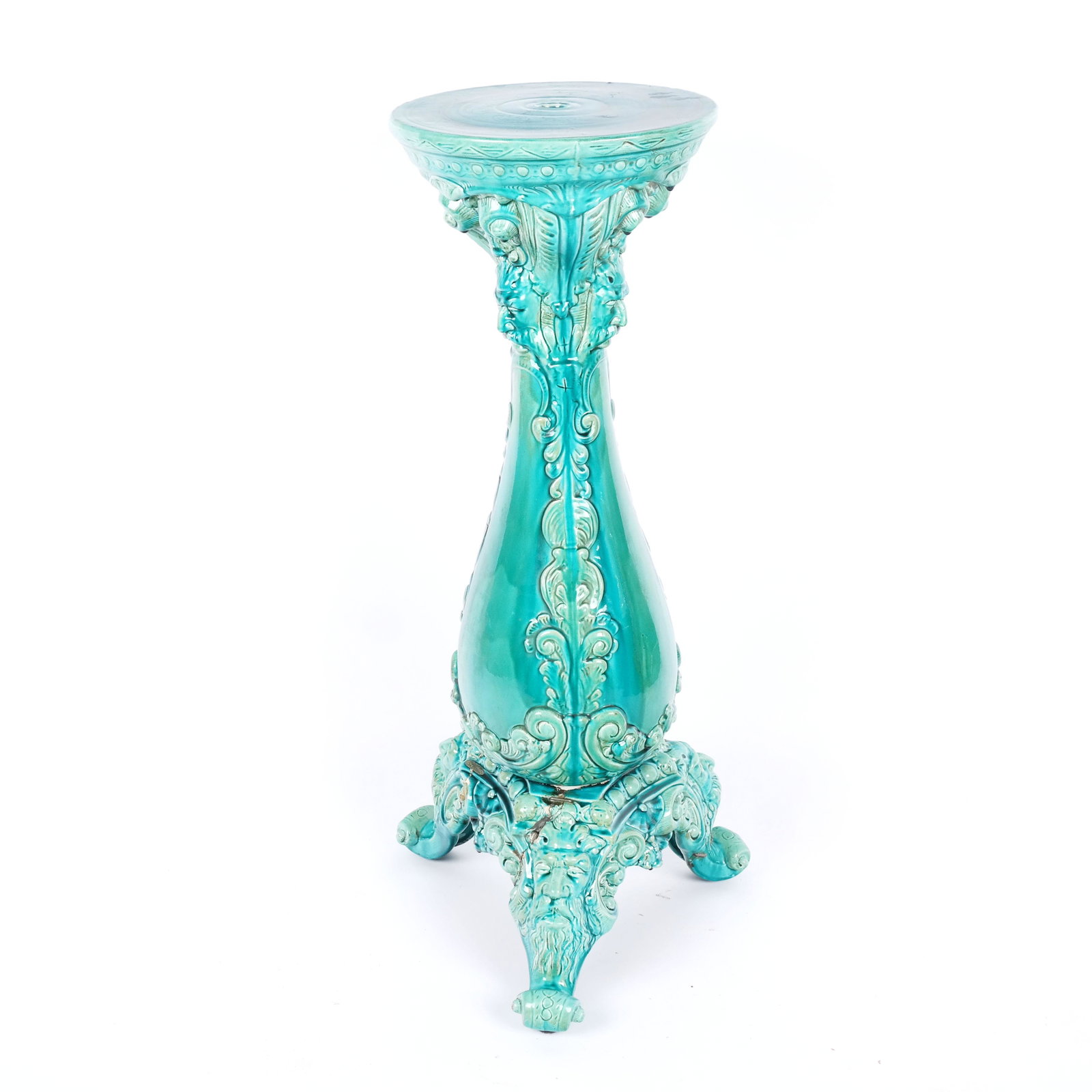 Majolica Plant Stand: Majolica plant stand in the manner of Minton with figural masks and scrolling details, marked to base. [37 1/2" H x 18" Diam.]. Cracks and repairs to feet and base.