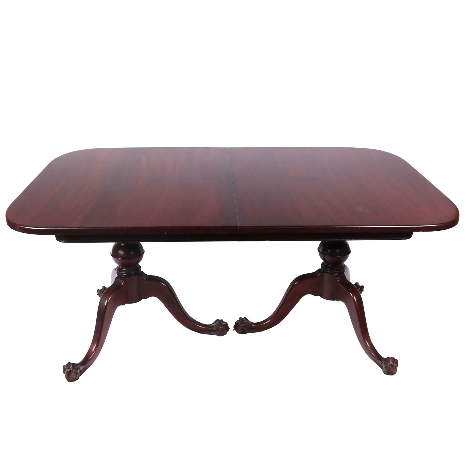 Georgian-Style Mahogany Dining Table: Georgian-style mahogany extension dining table, on tripod pedestal bases with claw and ball feet, with three leaves. [29 1/2" H x 66" W x 44" D; Leaves (x3): 12" W]. Stains and marks to top; one leaf