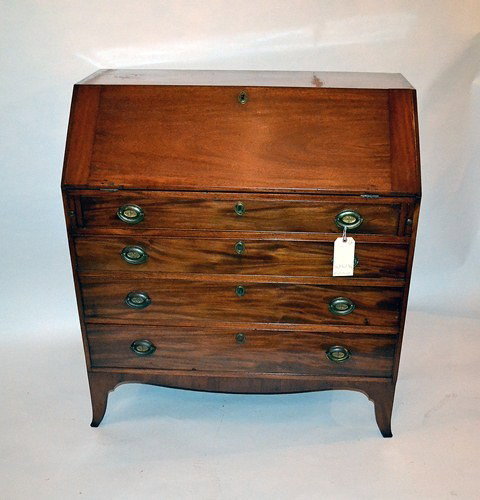 Antique Slant Front Desk: Antique slant front desk with seven interior drawers and eight cubby holes. Features original brass pulls and escutcheons. 41" W x 21" D x 45" H.