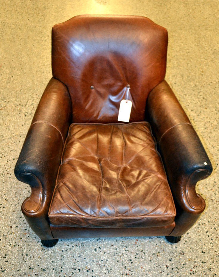 Brown Leather Club Chair: Brown leather club chair on carved wood feet. Cracked leather on arms and loose seams. 33"W x 37"D x 32"H. (14"H to seat)