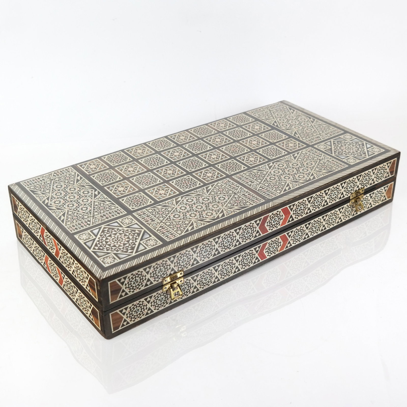 Late 20th C. Levantine Inlaid Games Board / Case: Levantine mixed wood games board/case with shell and bone geometric inlay, the exterior with chess/checkerboard and backgammon to interior. [3 1/4" H x 19 3/4" W x 9 7/8" D (closed)]. Case only, no pi