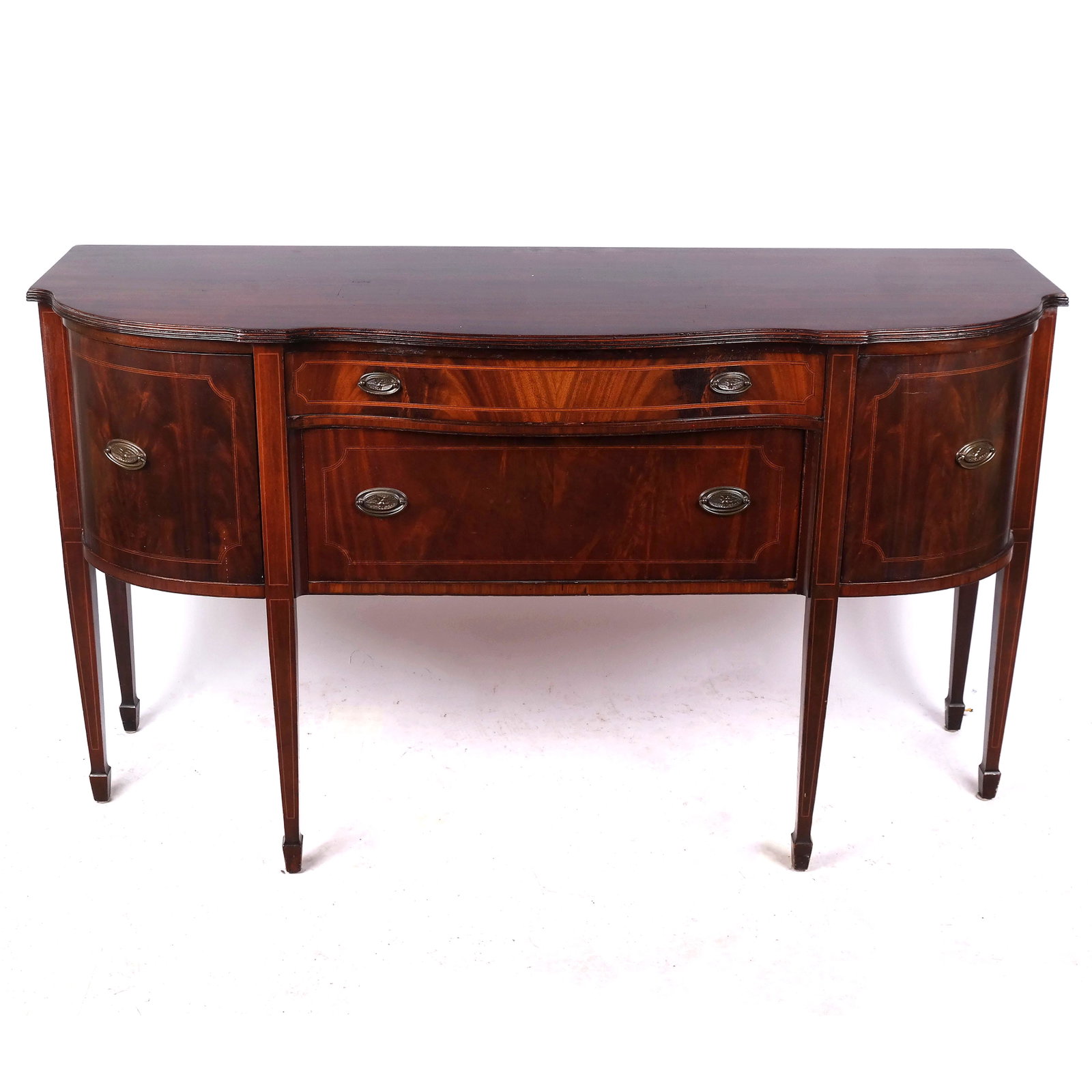 Hepplewhite-Style Mahogany Sideboard: Mahogany serpentine sideboard with two drawers and two doors. [38" H x 66" W x 22" D].