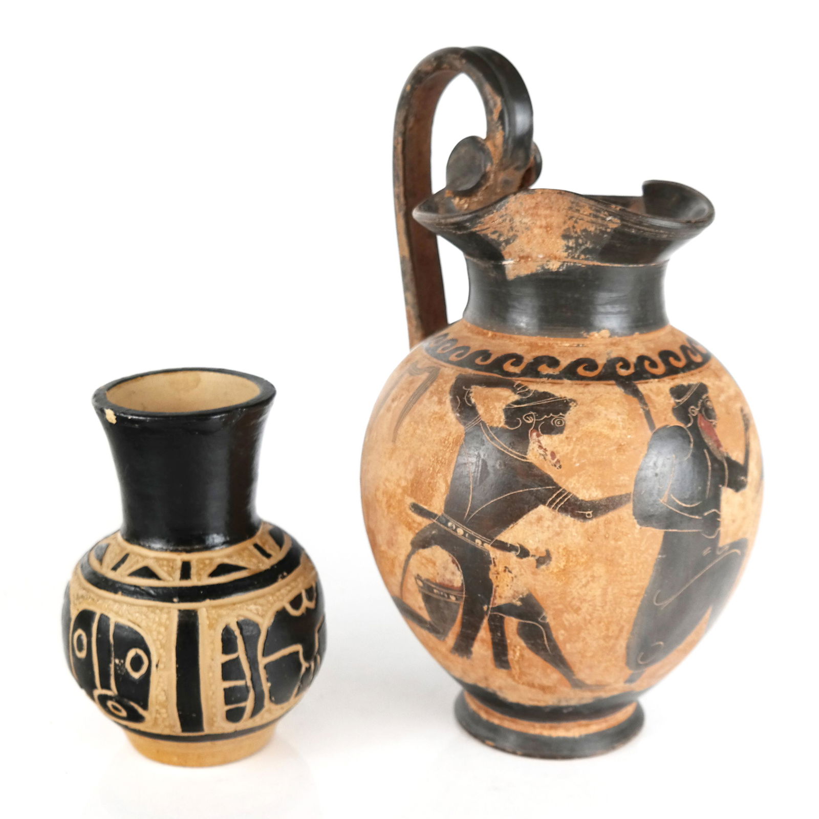 Two Ceramic Pottery Vessels: Two ceramic pottery vessels, the larger after the Greek antique of Oinochoe-form with figures and bird, the other with geometric and Mesoamerican motifs. [Larger: 11 1/2" H x 7 1/2" Diam.]. Some resid