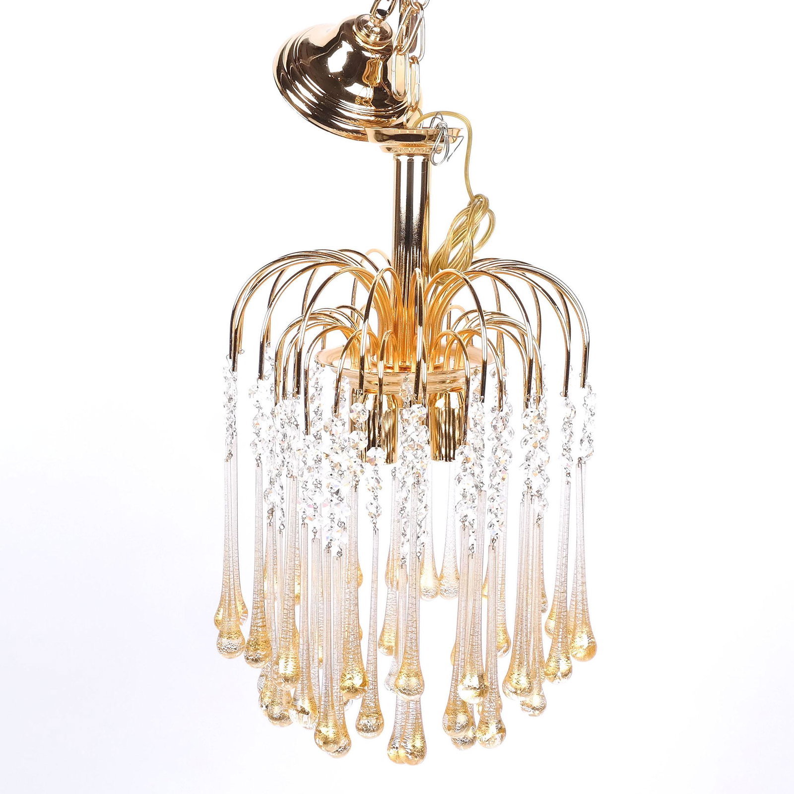 Modern Gilt Metal & Glass Chandelier by Murano: Modern gilt metal and Murano Italy glass chandelier having four lights, after a model by Paolo Venini, with retro waterfall outline and faceted prisms above elongated Murano gold-flecked drops. [20" H
