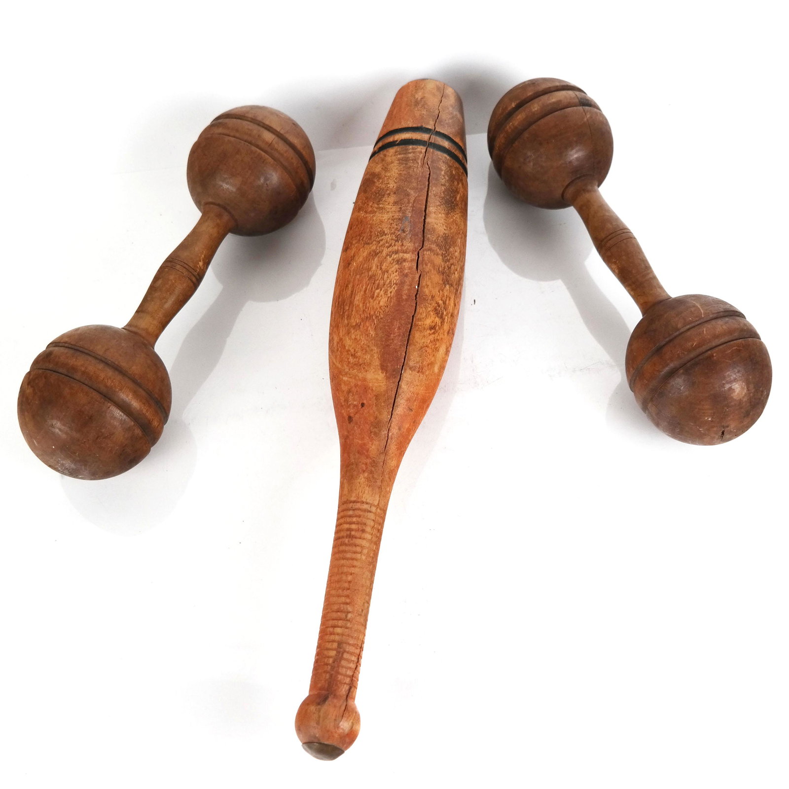 American Carved Wood Dumbbells & Juggling Pin: American carved wood dumbbells and juggling pin. [Pin: 16 1/2" L]. Cracks, marks, wear.