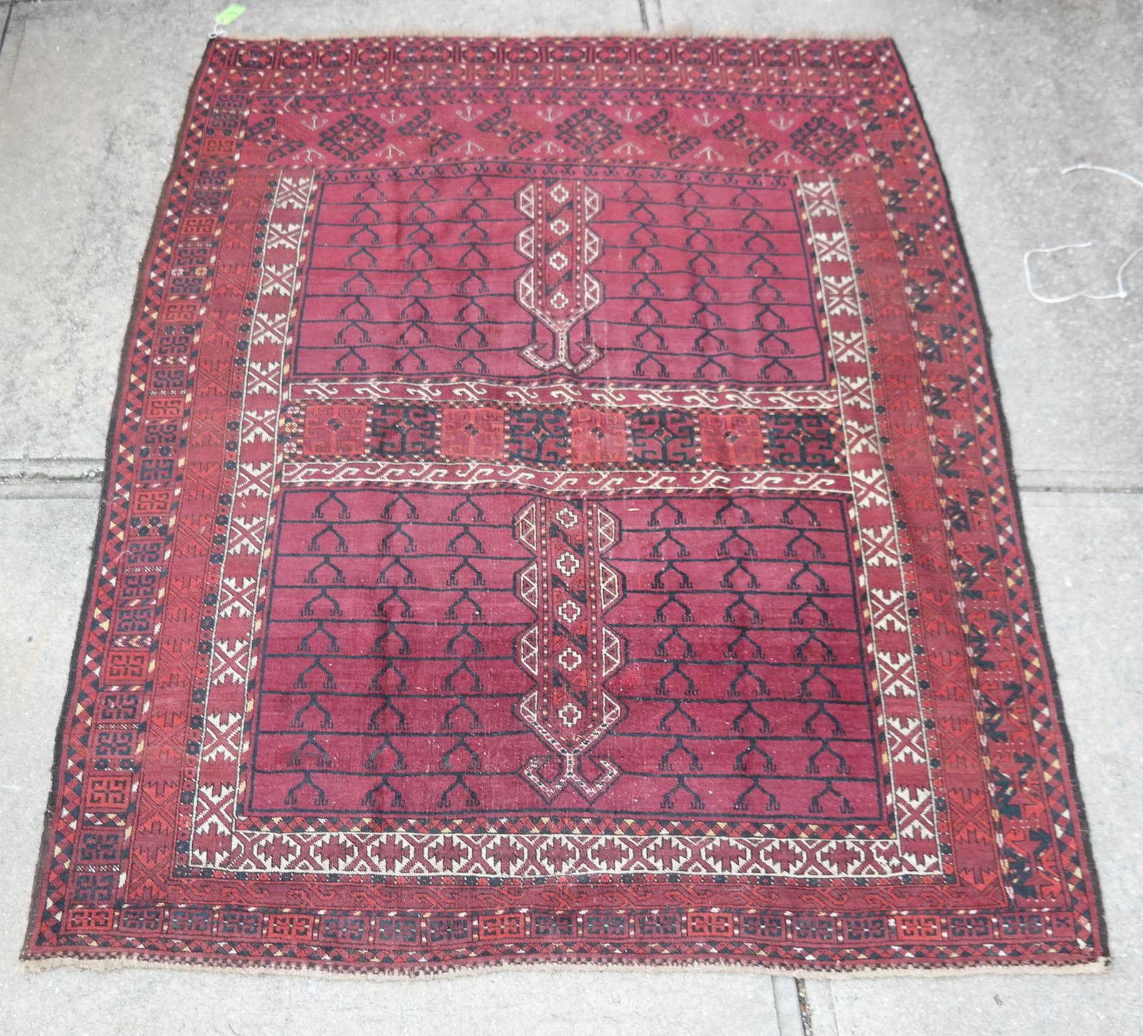 Afghan Rug: Afghan rug with Tekke design of black on brown with stripe at center, having rosette border. [5' 10" H x 7' 8" W].