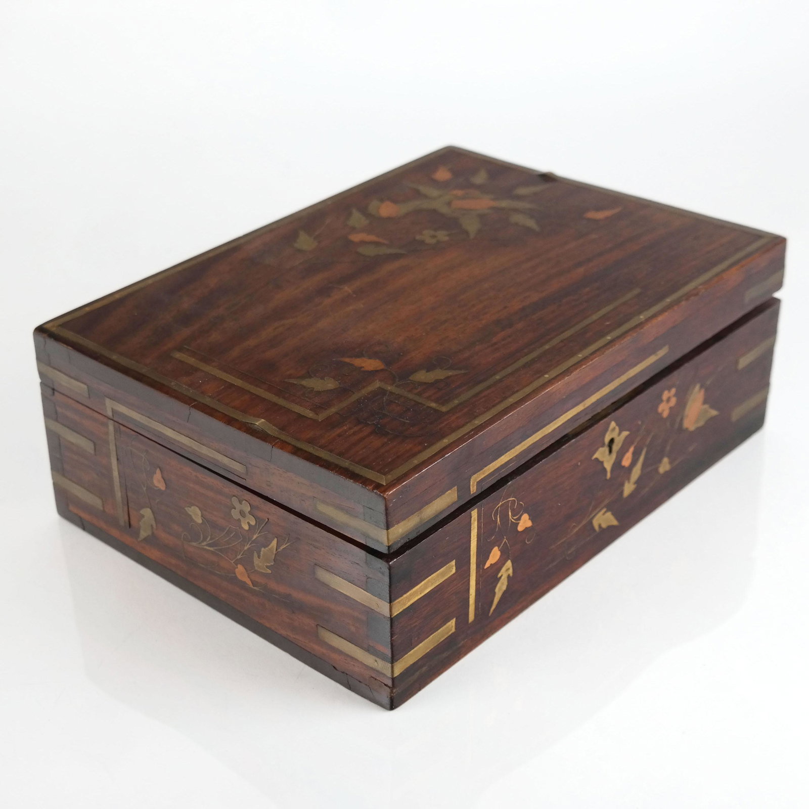 Brass Inlaid Wood Jewelry Box: Brass inlaid wood jewelry box, having inlaid bands with foliate motifs, velvet lined interior and tray, the interior lid with inlaid signature "J.B. Martell". [3 3/4" H x 10" W x 7 3/8" D]. Lifting to