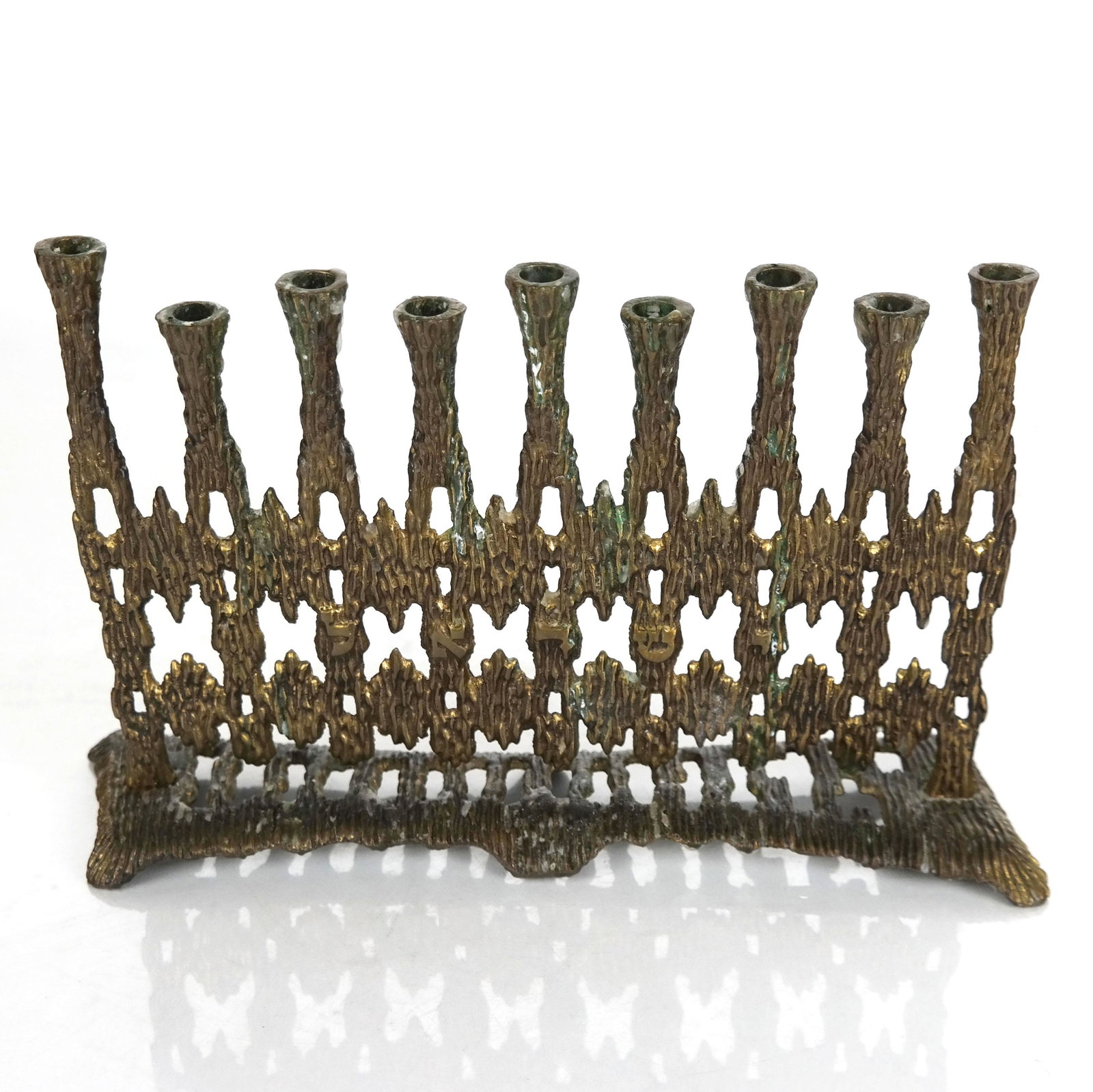20th Century Hein Ami Israeli Brass Menorah: 20th century Hein Ami Israeli brass menorah; signed to base. [6" H x 5" W x 9 1/4" D]. In good condition.
