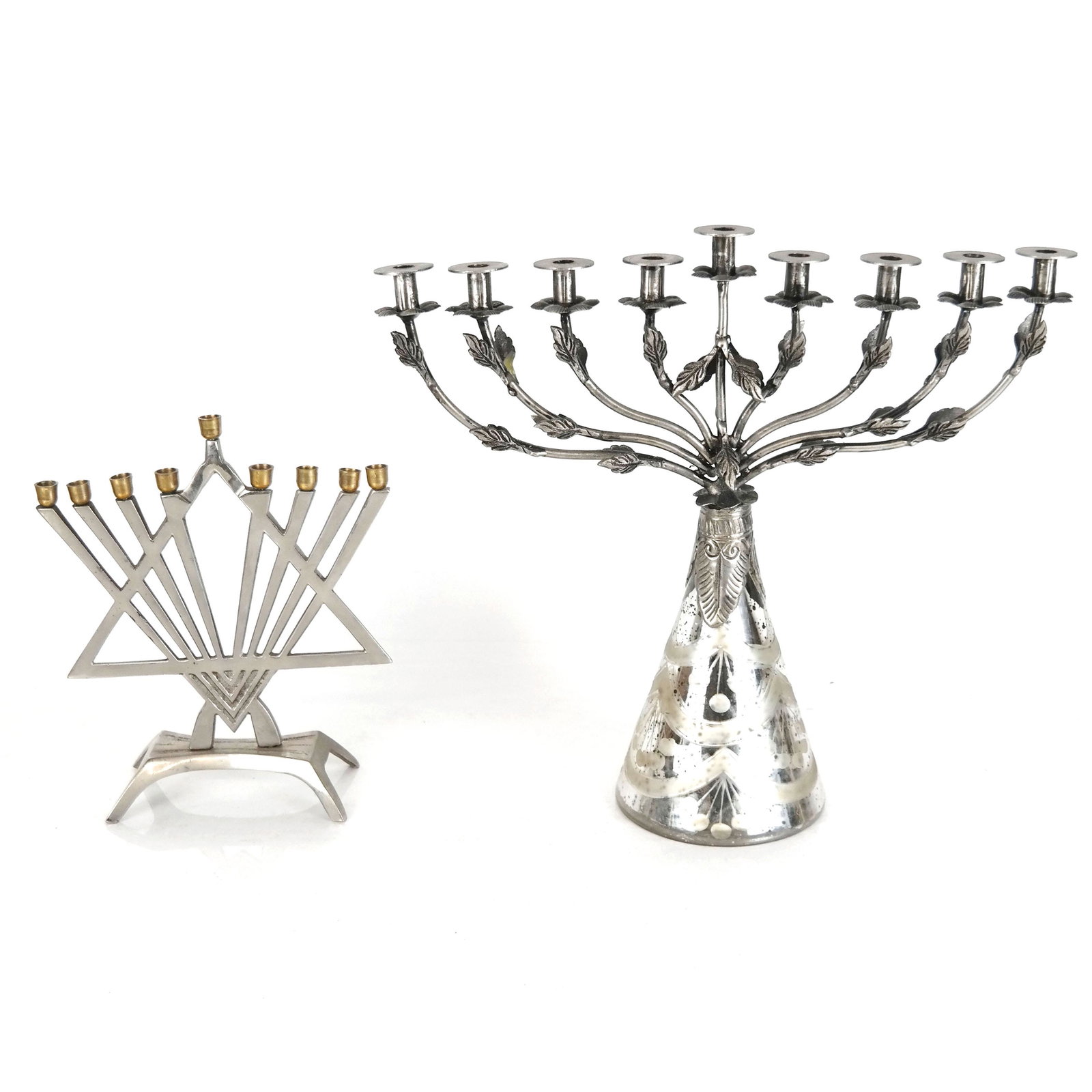 Two Metal Menorahs: Two metal menorahs, the larger with etched mercury glass base. [Larger: 12" H x 13 1/2" W x 4 1/2" D]. Some bending, oxidation, and wear.