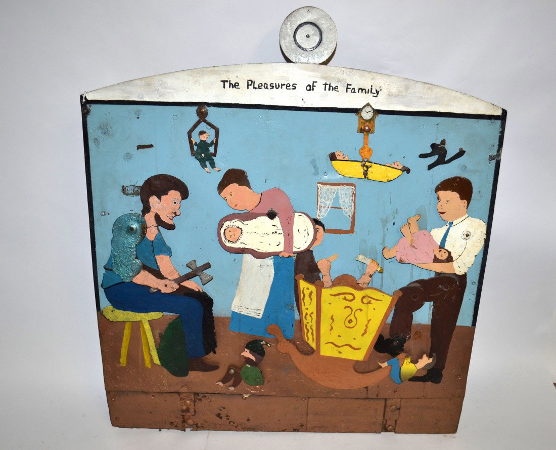 Whimsical Folk Art "The Pleasures of the Family": Whimsical kinetic folk art target game titled at top "The Pleasures of the Family." Reverse bears a crank that turns gears and rings a bell as figures on front move simultaneously. Constructed of iron