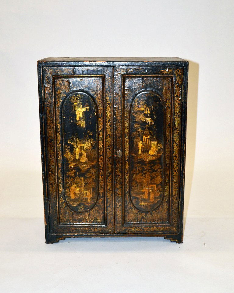 Antique Asian Lacquered Table Cabinet: Antique Asian lacquered table cabinet. Features all-over Buddhist temple and scholar decor. Bear two doors concealing eight interior drawers. 16" x 8.25" x 21" H. As is, exterior water damage and chip