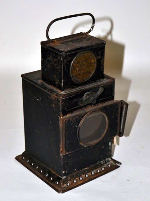 Antique English Tole Bromide Lamp: Antique English tole lantern with stamped brass medallion "The Bromade Lamp/Marion & Co…Soho Square/London…" 5" x 5" x 8 1/8" H. Losses to paint and some oxidation, otherwise complete.