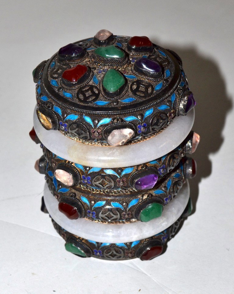 Jewelled Mongolian Silver Cylindrical Box: Mongolian silver cylindrical box. Bears four bands of roughcut and polished multi-colored hardstones with two white jade band accents. As is, missing one stone, otherwise in good condition