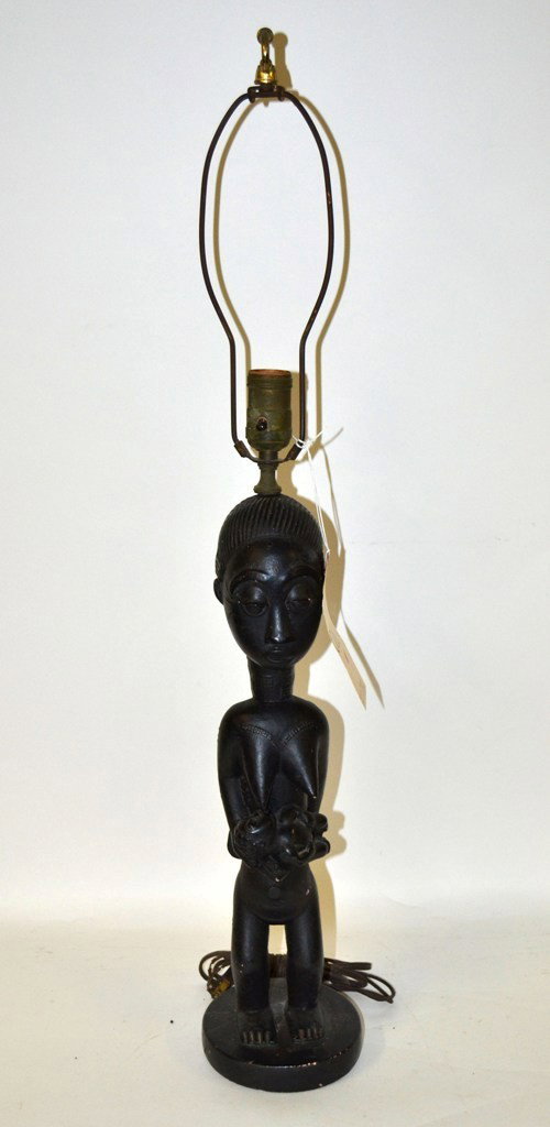 African Carved Ceramic Sculpture Lamp: African carved ceramic sculpture mounted as a table lamp. Depicts a nursing mother with second child on back. 5" dia at base x 21 3/4" H to socket. Minor chips and cracking, otherwise good condition.