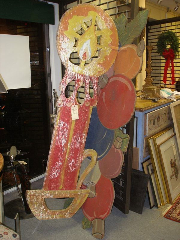 Vintage Outdoor Christmas Display: Vintage outdoor Christmas display. Festive composition including a cascade of ornaments with holly leaves, and a red candle with bright light. 26" x 24" x 78" H. Weathered condition, though complete.