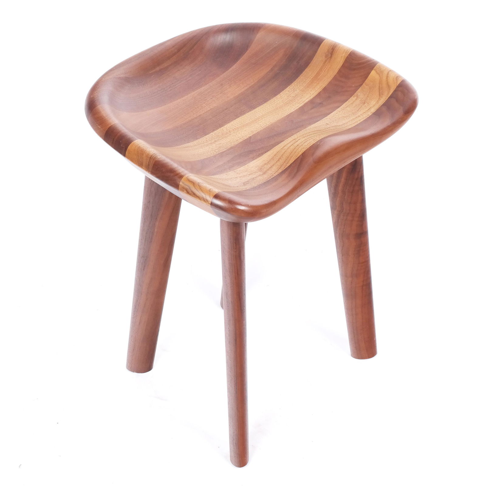 Bassamfellows Walnut "Tractor" Stool: Bassamfellows walnut "Tractor" stool with contoured seat, on splayed legs; with retail sticker to base. [19 1/2" H x 17 1/2" W x 14" D]. Scuffs and impressions to seat and legs.