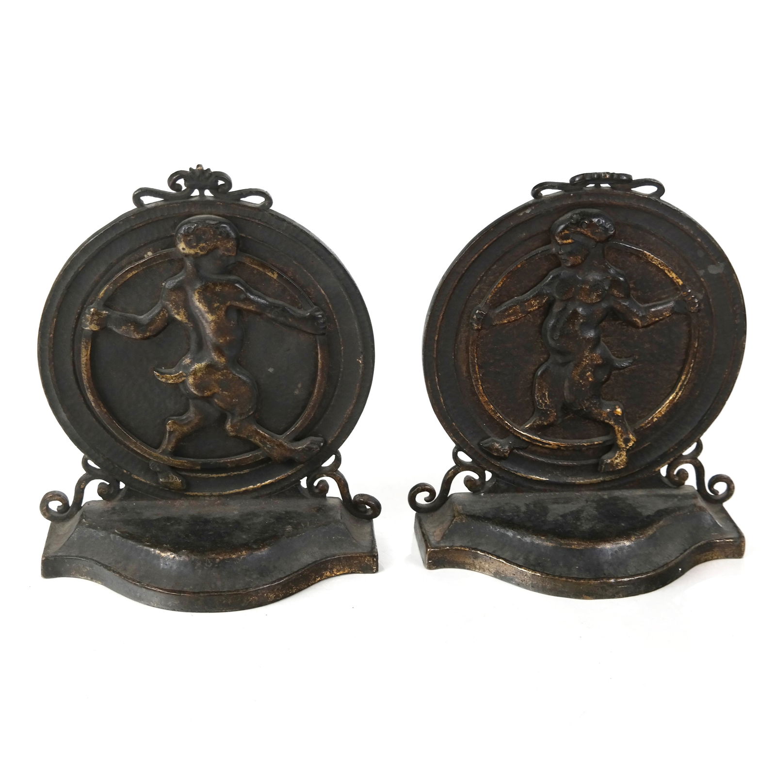 Pair of Bronze Bookends Cast with Faune: Pair of bronze bookends cast with faune, modeled front and back within hoop. [8 1/2" H x 6 1/4" W x 3" D]. Top finials and one side detail bent.