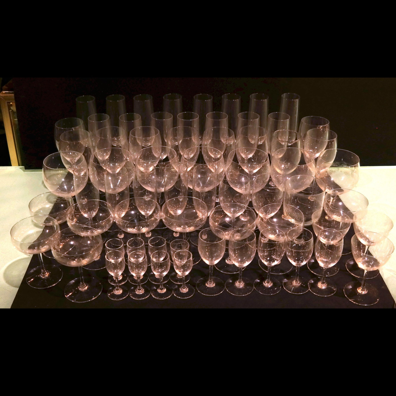 Assembled Group of Bar Stemware (70 Pcs.): Assembled group of 70 pieces of bar stemware, including champagne flutes and coupes, wine goblets, and cordial glasses. Some with light residue and wear.