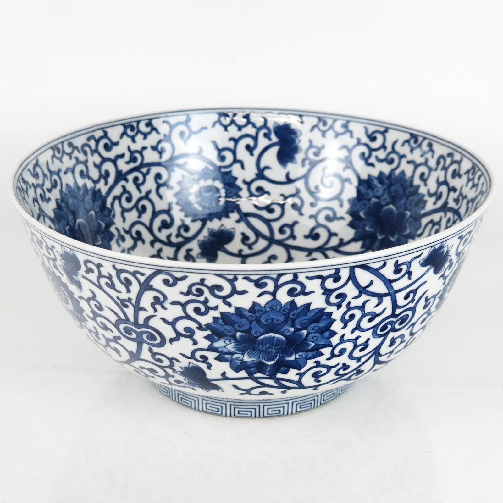 Chinese Blue & White Porcelain Bowl: Chinese blue and white porcelain bowl, overall with scrolling floral decoration; with character marks to base. [5 3/8" H x 12 1/2" Diam.]. Minor wear.