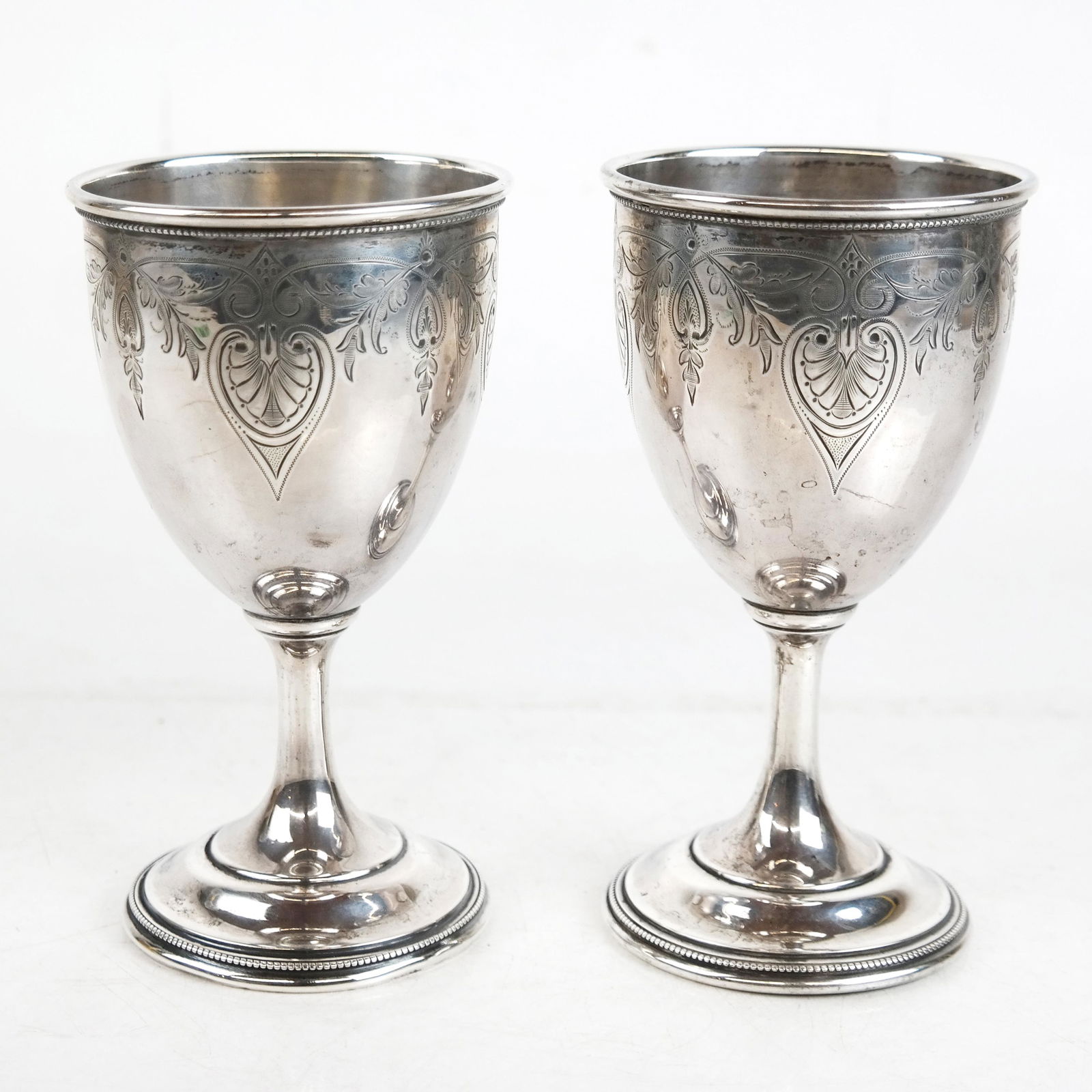 Pair of Krider & Biddle Silver Goblets: Pair of silver goblets by Krider & Biddle, having bell-shaped bowls, tapered stems, stepped foot and beaded moldings; George Sharp JNR, Atlanta G.A., after 1871. Stamped "925" to base. [6" H x 3 1/2"