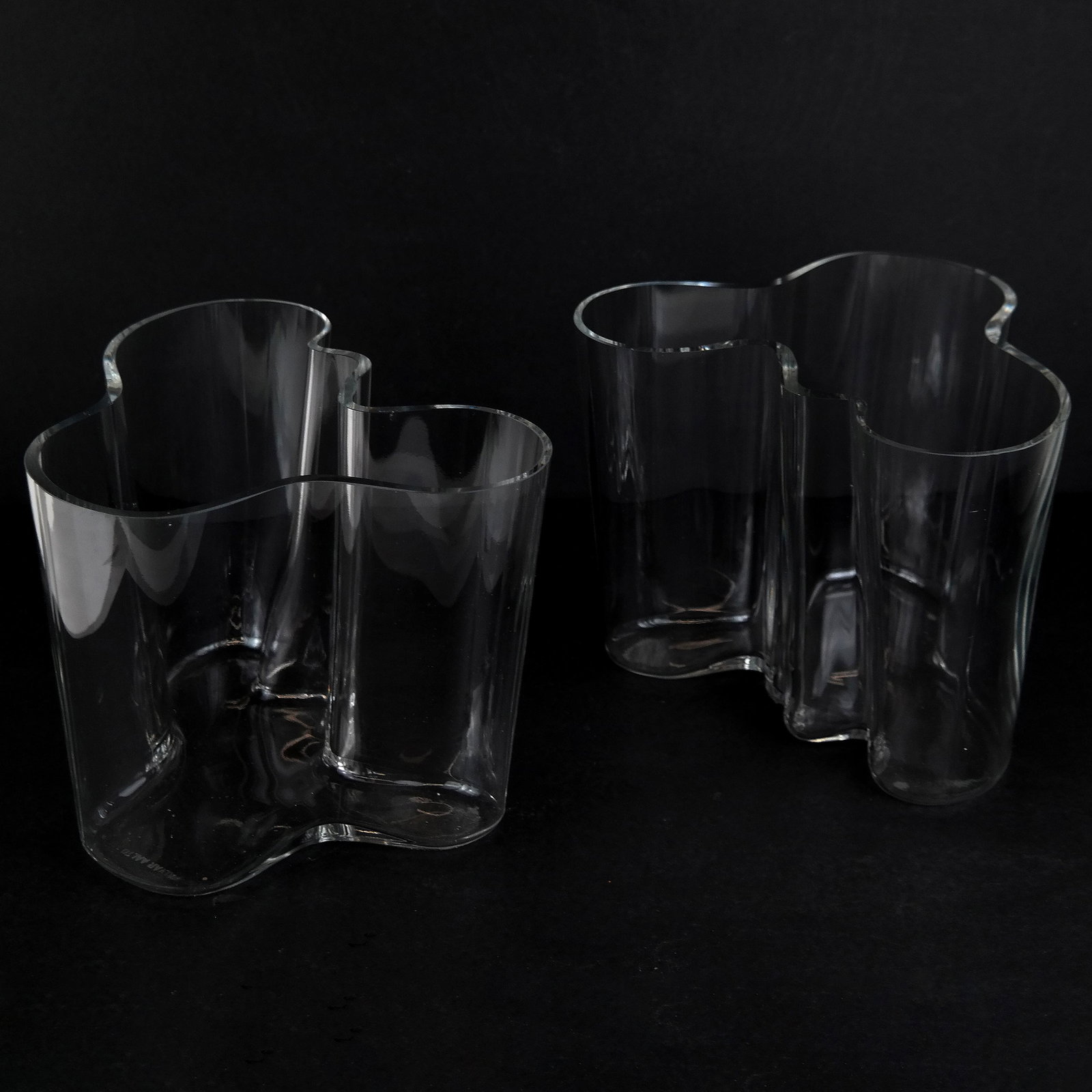 Pair of Alvar Aalto Glass Vases: Pair of Alvar Aalto glass vases. [6 1/2" H x 8 1/4" W x 7" D]. In good condition.