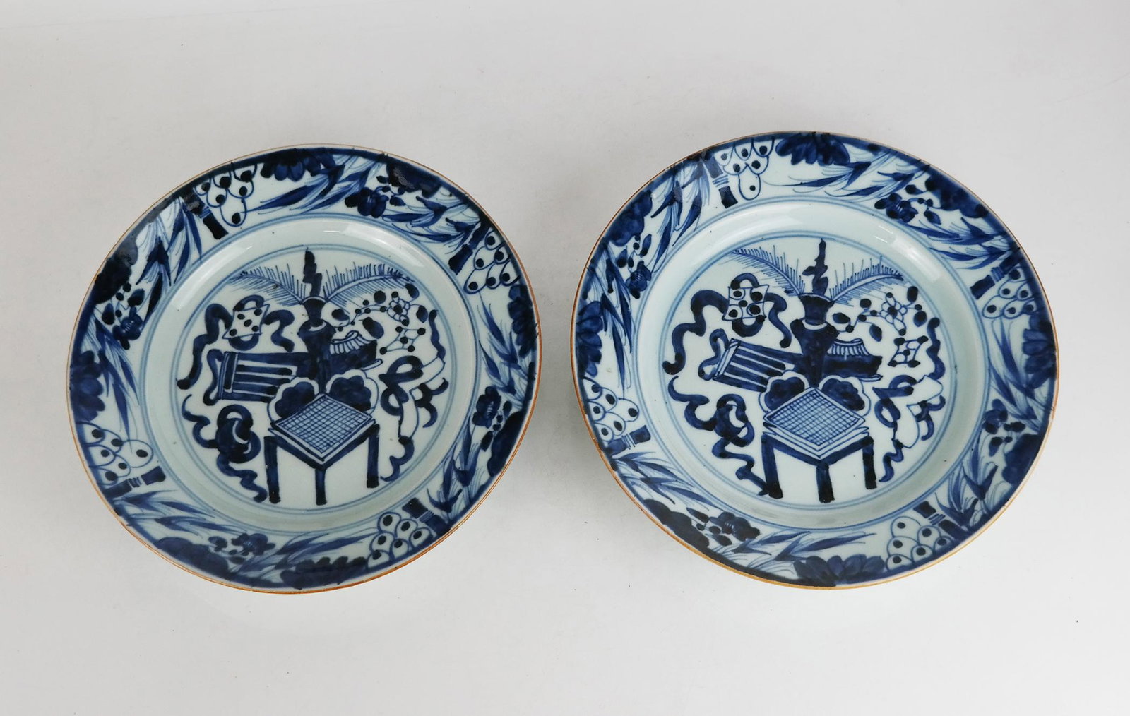 Pair of Chinese Blue & White Dishes: Pair of Chinese blue and white dishes with typical hand painted decoration; seal mark to rear. Minor manufacturing imperfections.