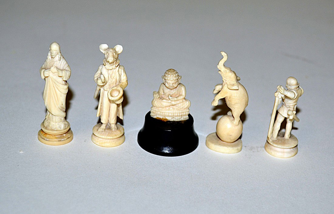 Five Ivory Figures: An elephant on a ball, a figure with an animal mask, a soldier, Buddha, and a figure of Christ. Tallest: 1.75", Smallest: 1".
