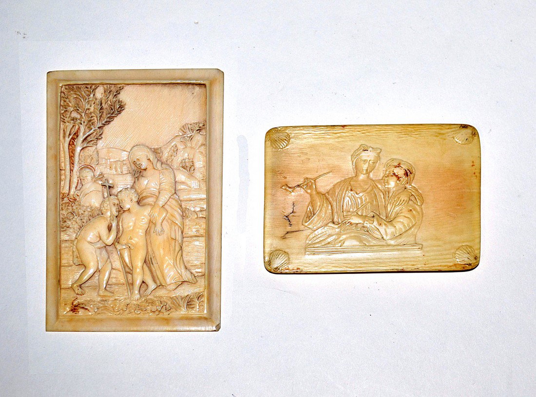 Two Ivory Reliefs: One European, depicting Mary and Jesus, the other, a box lid with a couple smoking. First: 7/8" x 2.75", second: 4" x 2.2"